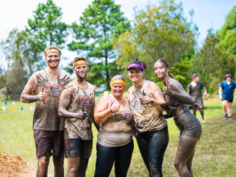 mud covered team raw challenge