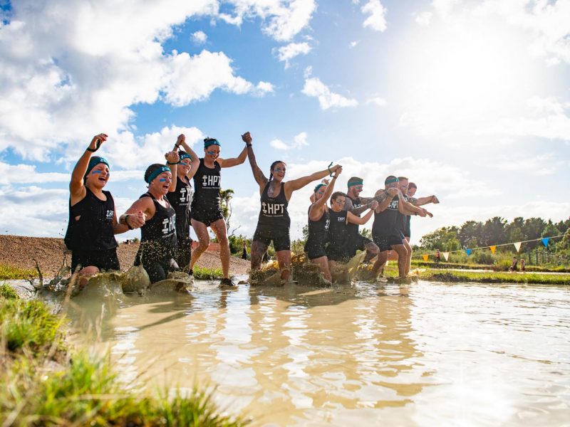 raw challenge team running through mud